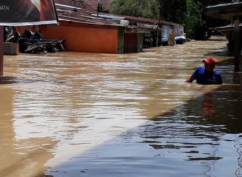 A resident wades through floodwater in Padangbulan district in Medan, North Sumatra, on Sept. 16.