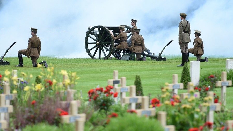 Men and women dressed as WWI soldiers load a cannon as they take part in a memorial ceremony, July 1, 2016