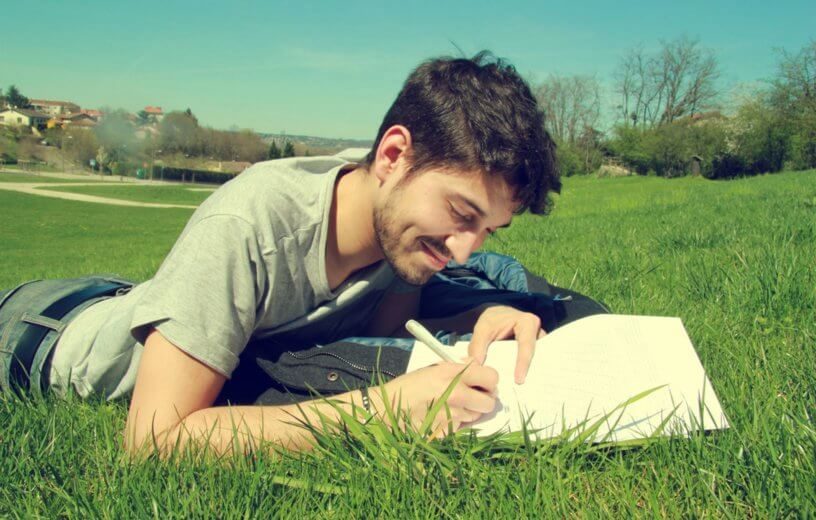 man writing grass