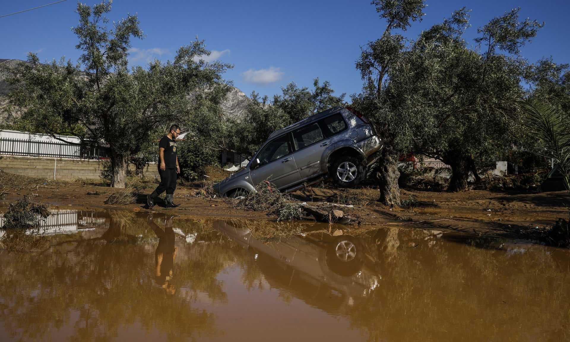 A car moved by flood water after storms in Kineta, Greece