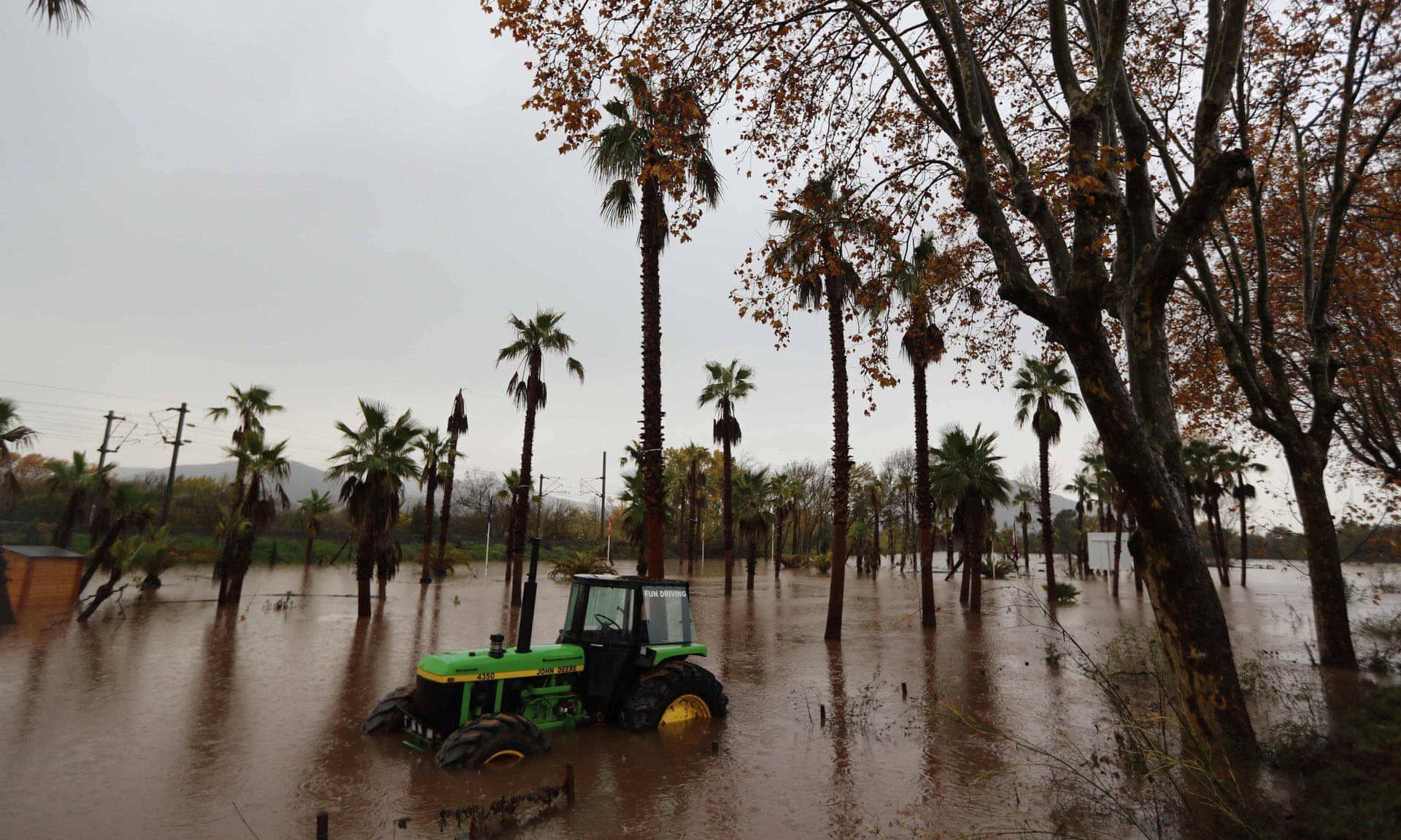 A tractor in a flooded area after heavy rain in Roquebrune-sur-Argens, France