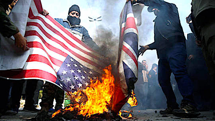 Demonstrators burn flags