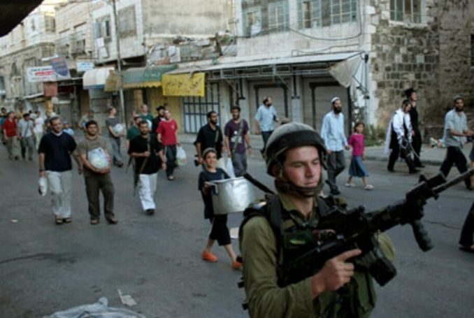 Jewish settlers, backed by Israeli soldiers