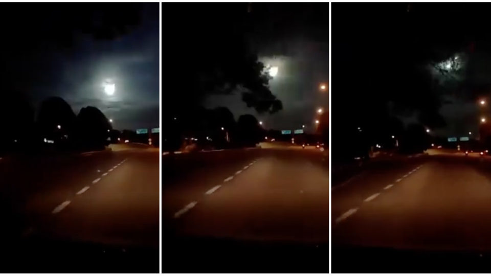 A fiery ball of light plummets through the sky as seen from Johor Bahru, Malaysia, in a dashboard camera recording.