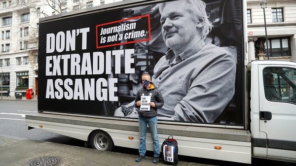 Demonstrator stands protest against the extradition of Julian Assange in London.