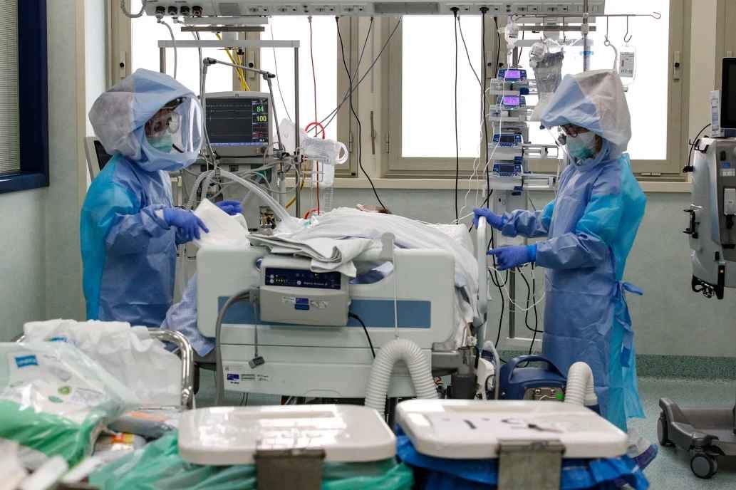 Health care professionals in protective suits