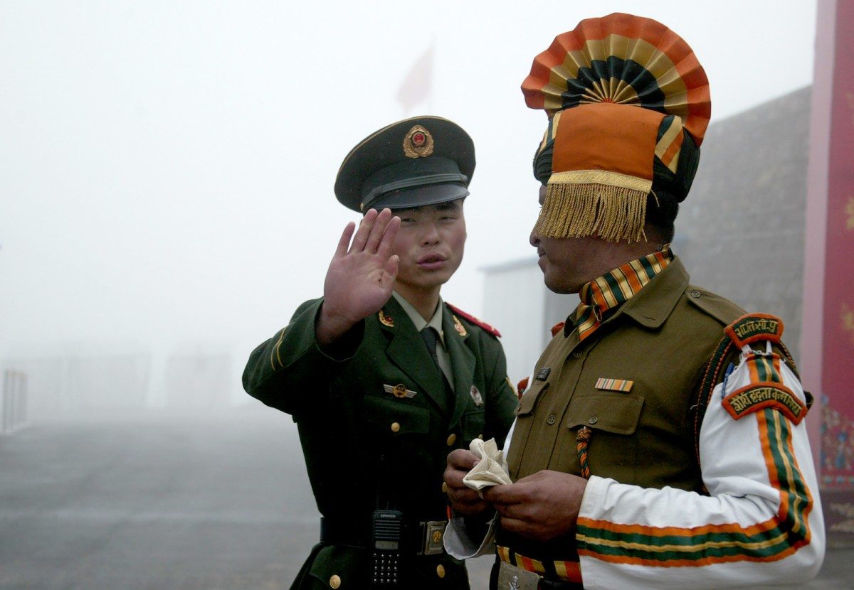 A Chinese soldier (L) next to an Indian soldier at a border crossing in a file photo.