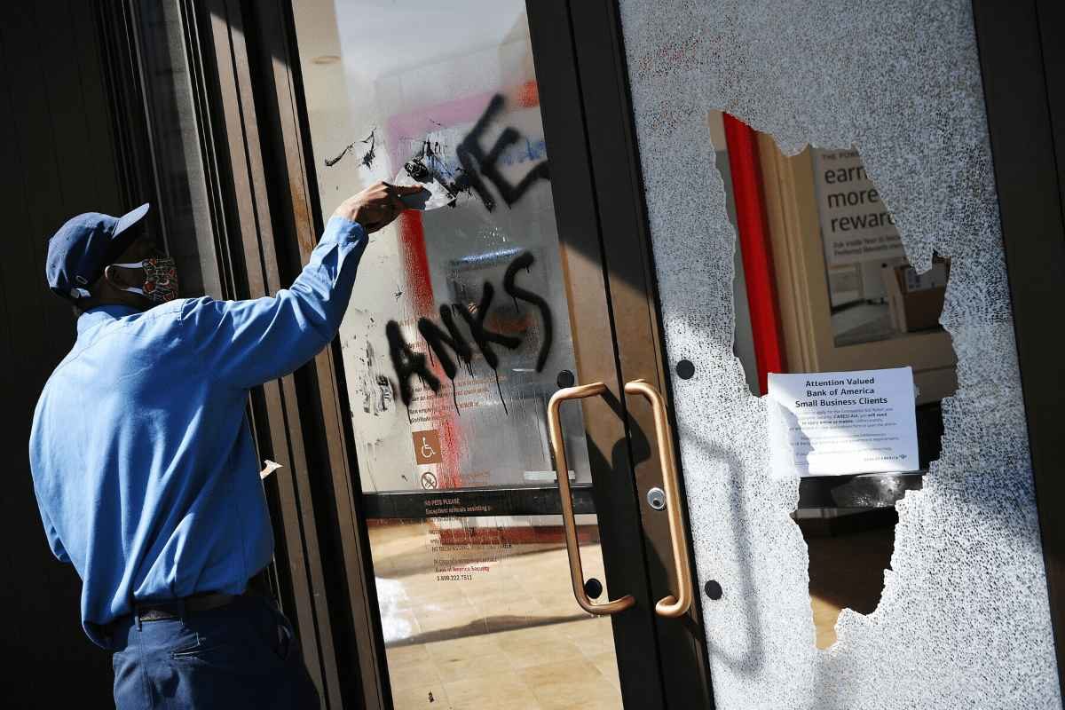man removes graffiti
