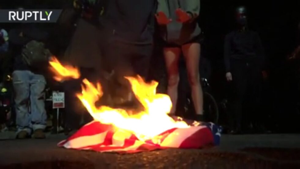 burning US flag and Bible