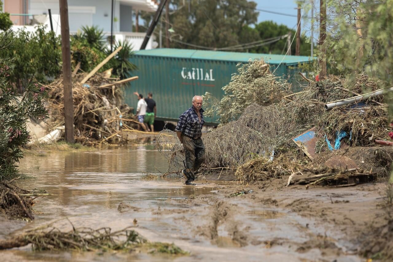 A man makes his way on a flooded street, following flash floods on the island of Evia, Greece, August 9, 2020.