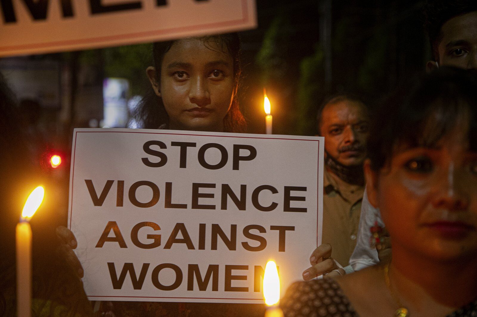 Indian women hold placards protesting against the alleged gang rape