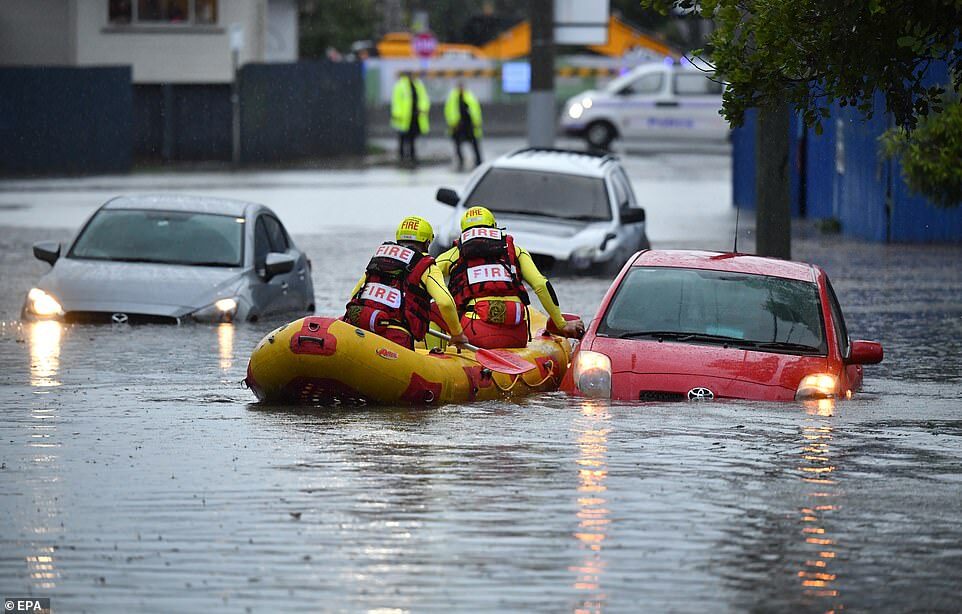 Members of the Swift Water Rescue team from the Queensland Fire and Emergency Services were seen searching flooded cars on Longlands Street at Woolloongabba in Brisbane on Tuesday afternoon