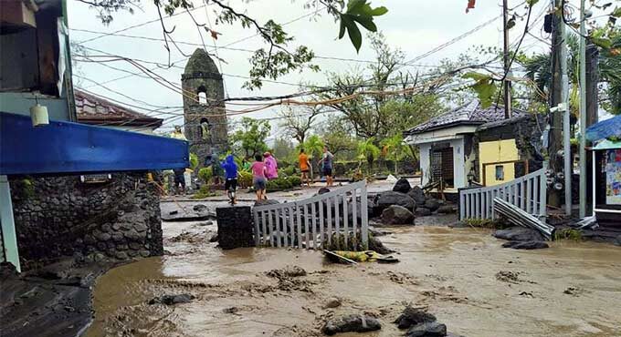 Floodwaters pass by Cagsawa ruins, a famous tourist spot in Daraga, Albay province, central Philippines as Typhoon Goni hit the area