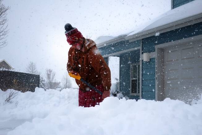 Tim Ahlman shovels snow outside his home in Bellemont, Ariz. Monday, Jan. 25, 2021. A series of winter storms have dropped more precipitation in Flagstaff than the city had during last summer’s monsoon season.