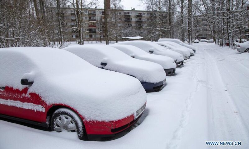 Vehicles are seen covered with snow in Riga, Latvia, on Jan. 30, 2021. A cyclone with a center at the Estonian-Russian border has brought a prolonged period of heavy snowfall to Latvia this weekend, meteorologists said Saturday.
