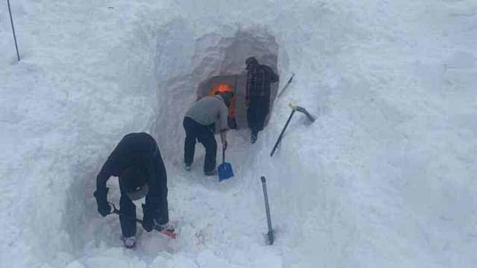Searchers dig a tunnel into 20 feet of snow that buried three victims after an avalanche in San Juan County, Colorado, on Monday, Feb. 1, 2021.