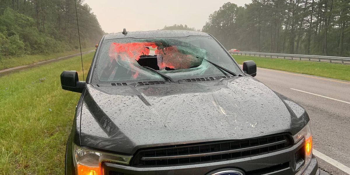 A lightning strike hit I-10 Monday morning, sending a piece of the road through a truck's windshield. Both occupants were injured.