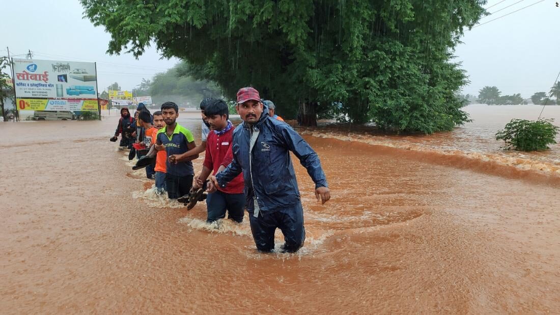 National Disaster Response Force personnel rescue people stranded in floodwaters in Kolhapur, in the western Indian state of Maharashtra, on Friday.
