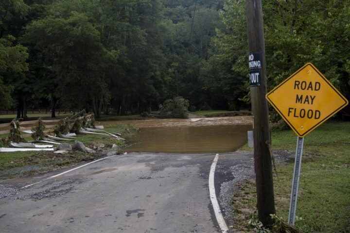 Water covers Sam Hollow Road following heavy rainfall on Saturday, Aug. 21, 2021, in Dickson, Tenn.