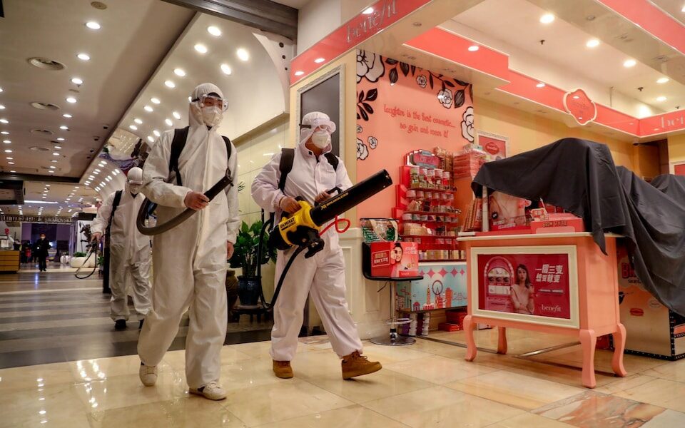 chinese workers disinfect mall