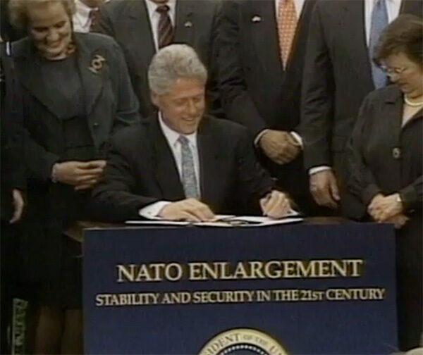 Bill Clinton signs NATO expansion legislation in May 1998.