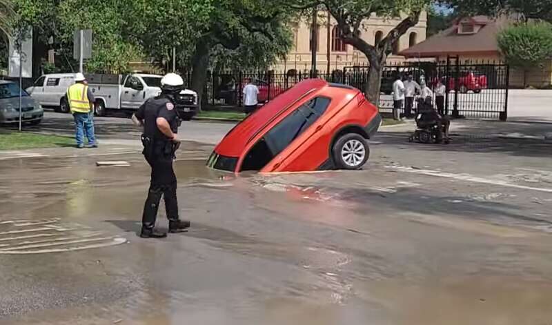 A man narrowly escaped from a car window after driving into a sinkhole in Galveston on Tuesday, May 23.