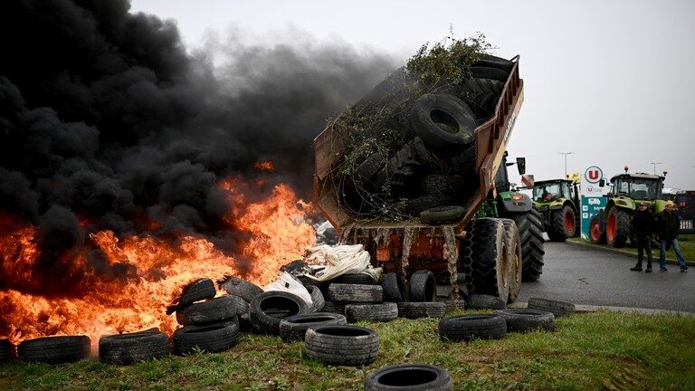 Farmers set branches and tires on fire
