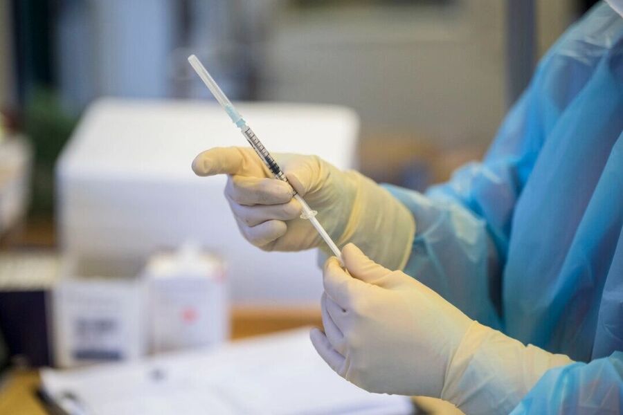 A healthcare worker prepares a Moderna COVID-19 vaccine.