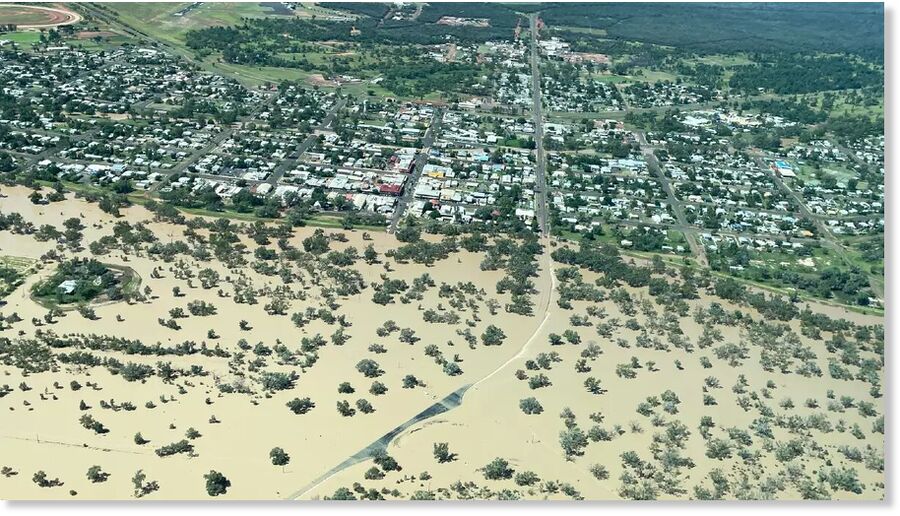 South West Aerial Services operator Alan MacDonald was able to view the levee bank's effectiveness from above, as the Warrego River reached its peak on Saturday.