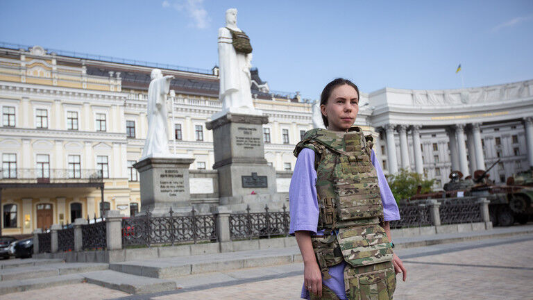 FILE PHOTO: A woman demonstrate body armor during a presentation in Kiev