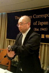 Tomohiko Suzuki shows reporters a watch