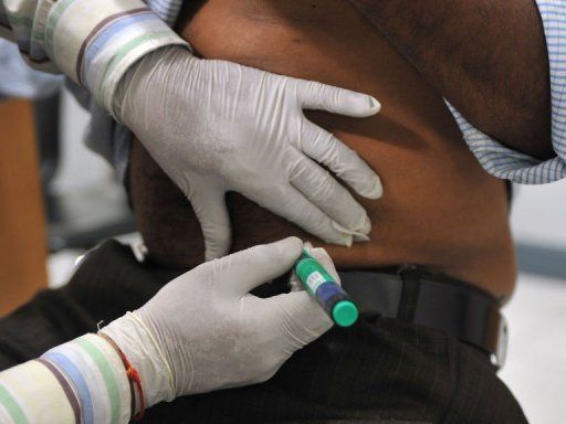 Indian medical assistant administers an insulin shot