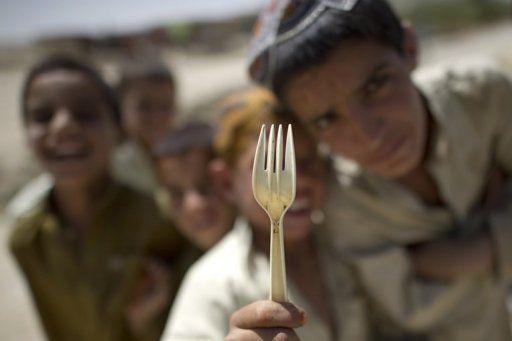 Click to enlarge Afghan boys beg for food