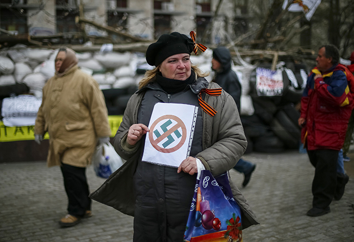 Pro-Russia protester holds an anti-swastika sign