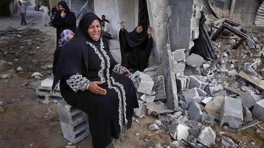 Palestinian woman in rubble