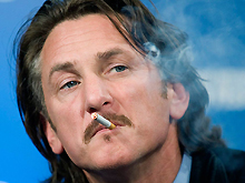 Actor Sean Penn listens to a question as he smokes during a news conference for the film All the Kings Men in Toronto last Sunday.