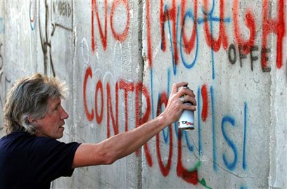 Roger Waters writing on the apartheid wall in Palestine