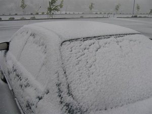 Car covered by snow in June