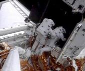 astronauts work on hubble