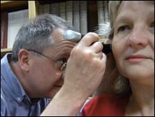 Click to enlarge Doctor examining patient