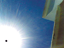Illustration of a ufo in front of the sun