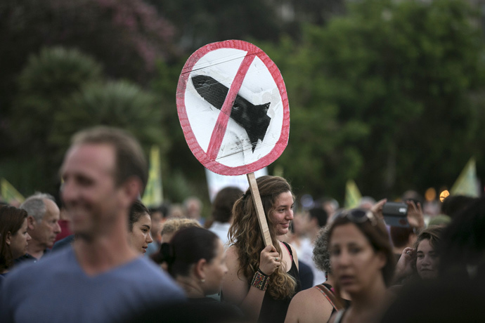 girl holds a sign during a rally