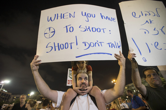 man holds a sign during a rally 