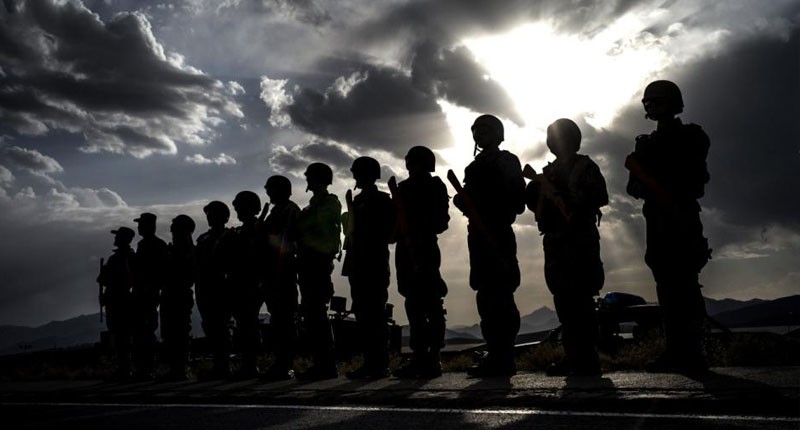 Afghan policemen stand guard