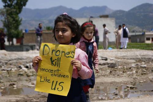girl with sign Drones kill