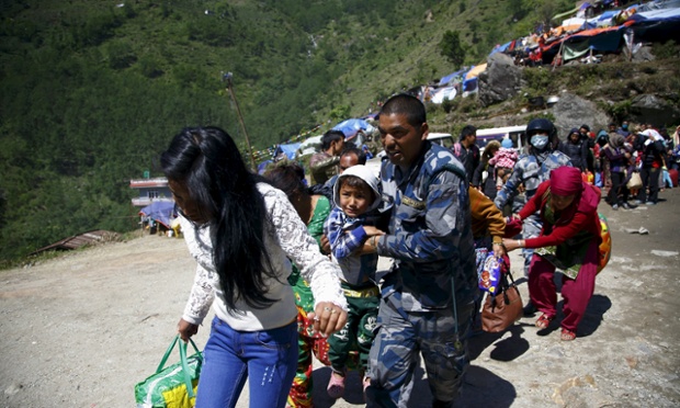 Armed Nepalese police help people