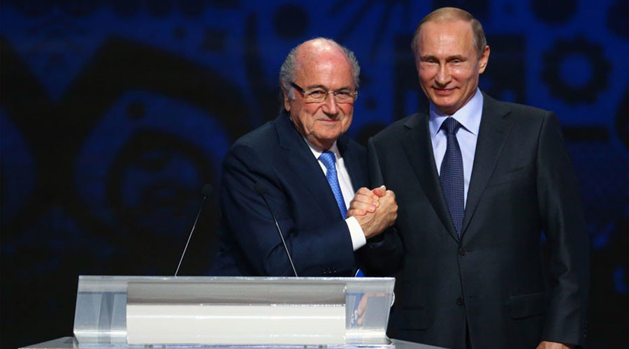 Click to enlarge FIFA's President Sepp Blatter shakes hands with Russia's President Vladimir Putin.