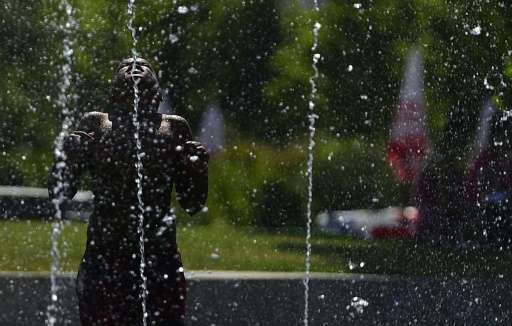 child cools off in fountain