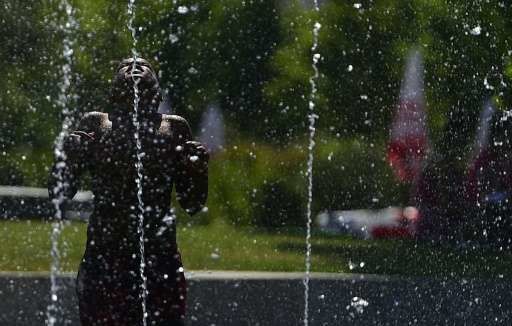 child cools off in fountain