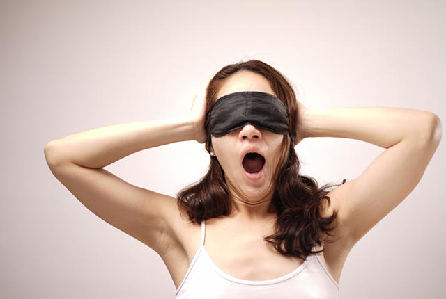 Click to enlarge Blindfolded woman yawning